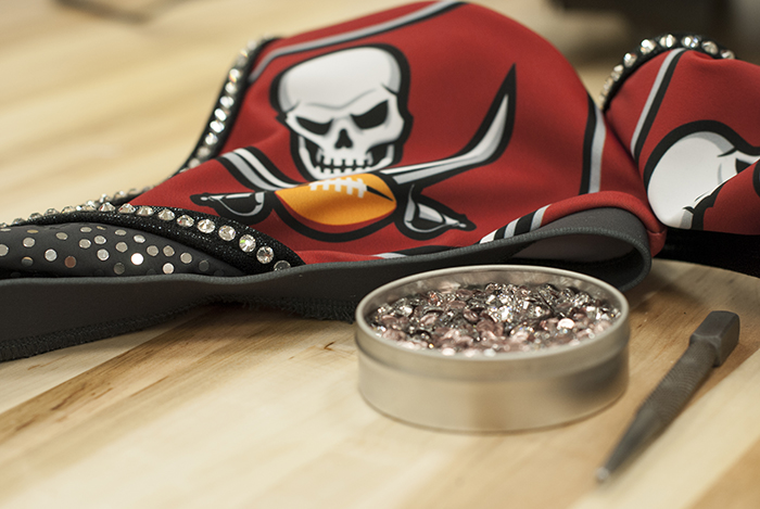 The Line Up - Tampa Bay Buccaneer Cheerleaders Signature Costume - Applying rhinestones