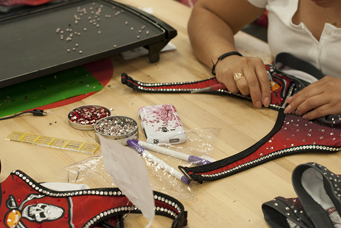 The Line Up - Tampa Bay Buccaneer Cheerleaders Signature Costume - Applying rhinestones to the costume