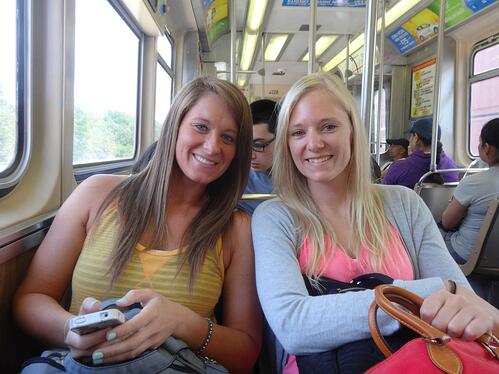 Megan and Melissa on their train ride into the city.  Smiling even though their luggage is lost.  