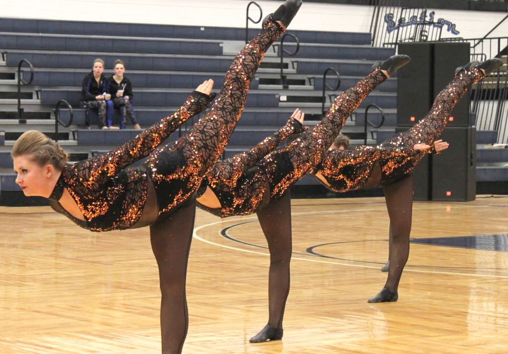 West Fargo Dance Team, The Line Up, high kick, copper and black dance costume, edgy, animalistic