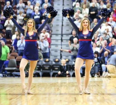 Uconn dance team cheering on the basketball court