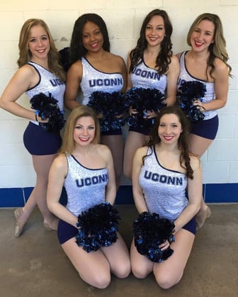 uconn dance team in sparkly white cheer tanks