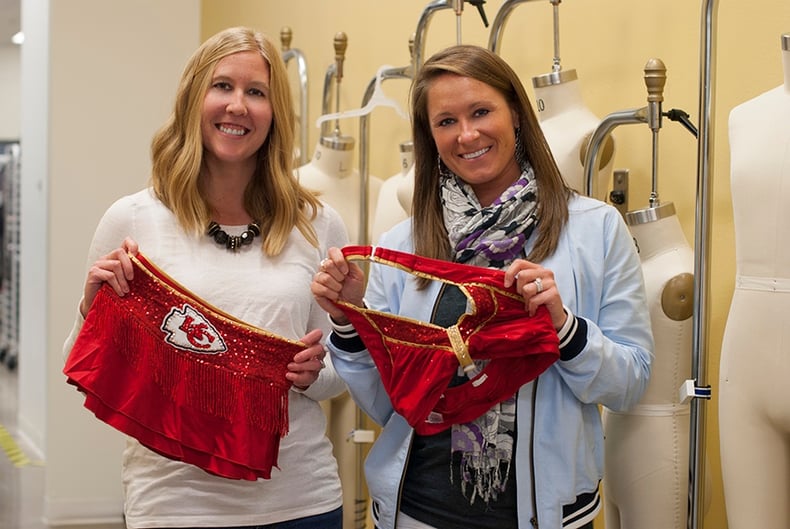 the line up employees pose with Kansas City Chiefs Cheerleaders new costumes 