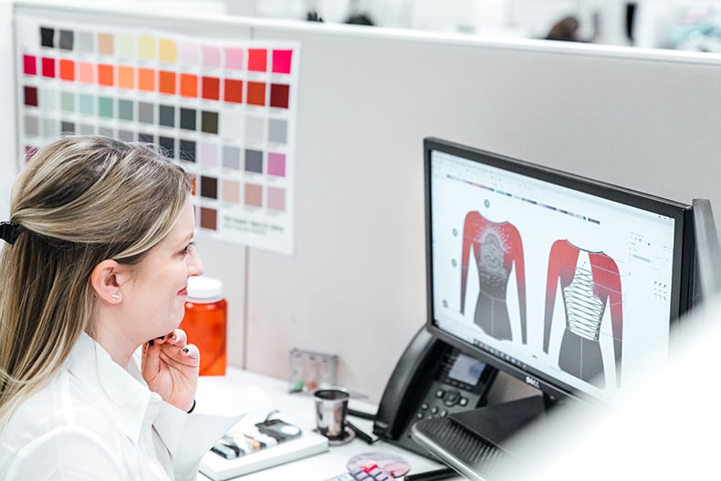 A designer sketching an illustration for the Design inspiration for Ohio State University dance team pom uniforms